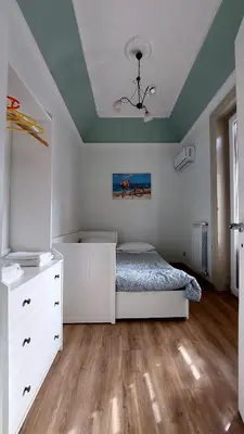 a bedroom with a bed and a dresser in it at Elenahouse alla Kalsa in Palermo