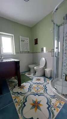 a bathroom with a sink and a toilet and a shower at Elenahouse alla Kalsa in Palermo
