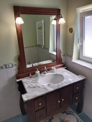 a bathroom with a sink and a large mirror at Elenahouse alla Kalsa in Palermo
