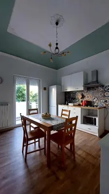 a kitchen with a table and chairs in a room at Elenahouse alla Kalsa in Palermo