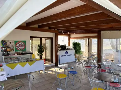 a room with tables and chairs in a kitchen at Hotel Iride by Marino Tourist in San Vito lo Capo