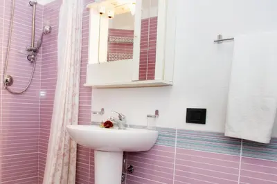 a bathroom with a sink and a mirror at Casa Longo in Castellammare del Golfo
