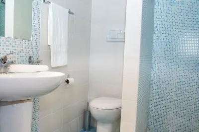 a bathroom with a toilet and a sink and a shower at Casa Longo in Castellammare del Golfo