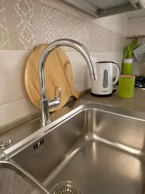 a kitchen counter with a sink and a cutting board at A casa da Carlo in Palermo