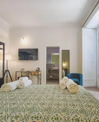 a bedroom with a large bed with towels on it at Dimora Carella Ai 5Venti in Palermo