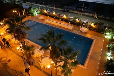an overhead view of a swimming pool at night at Hotel Sirenetta in Isola delle Femmine