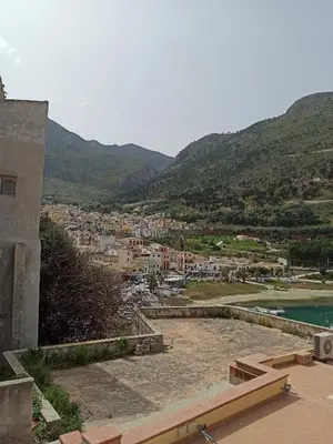 a view of a town with mountains in the background at NARDINA HOUSE in Castellammare del Golfo
