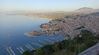 an aerial view of a city with boats in a harbor at NARDINA HOUSE in Castellammare del Golfo