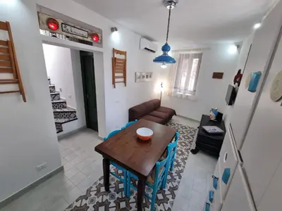 a living room with a table and a couch at Casa viotti Le fuoriserie in Palermo