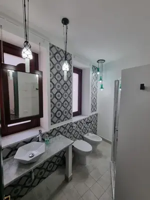 a bathroom with a sink and a toilet and a mirror at Casa viotti Le fuoriserie in Palermo