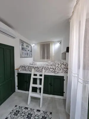a bedroom with a bed with a ladder in it at Casa viotti Le fuoriserie in Palermo