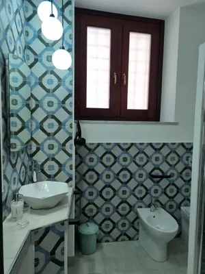 a bathroom with a sink and a toilet at Casa viotti Le fuoriserie in Palermo