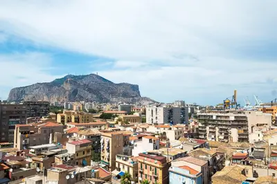 a view of a city with a mountain in the background at Hotel Vecchio Borgo in Palermo