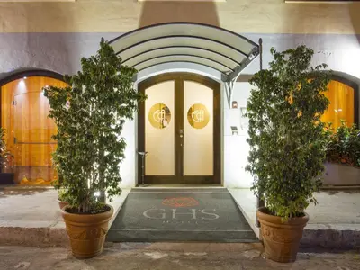 two potted trees in pots in front of a door at Hotel Vecchio Borgo in Palermo