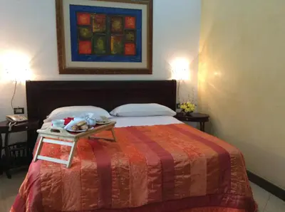 a hotel room with a bed with a tray on it at Albergo Verdi in Palermo