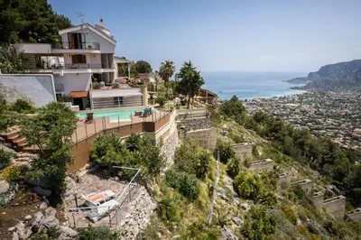 a house on a hill with a view of the ocean at Villa vista mare con piscina privata a Mondello in Palermo