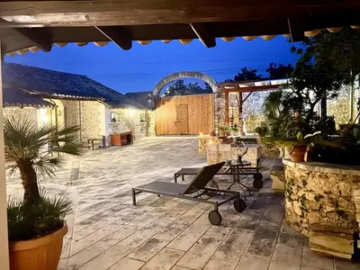 a patio with a bench and a table in a building at Baglio Giganti in Alcamo