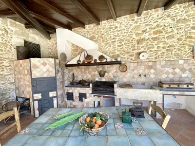 a kitchen with a table with a bowl of fruit on it at Baglio Giganti in Alcamo