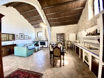 a large kitchen with a couch and a table at Baglio Giganti in Alcamo