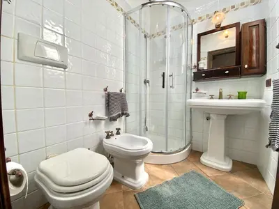 a bathroom with a toilet and a shower and a sink at Baglio Giganti in Alcamo