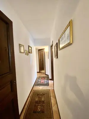 a hallway with a door and a rug on the floor at Baglio Giganti in Alcamo
