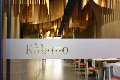a sign for a kalaiba store with tables and chairs at Villa Scaduto Residence in Bagheria
