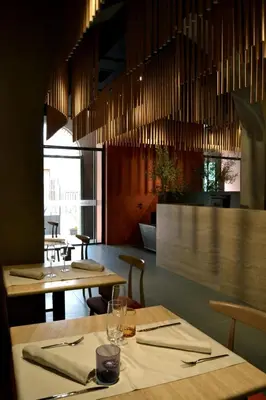 a restaurant with two tables and chairs and chandeliers at Villa Scaduto Residence in Bagheria