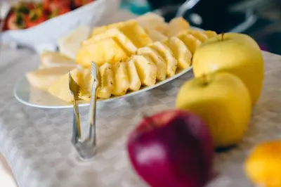 a plate of cheese and apples on a table at Hotel Piccolo Mondo in San Vito lo Capo