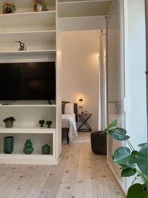 a bedroom with a large bed with a mirror at Maison Opéra in Palermo