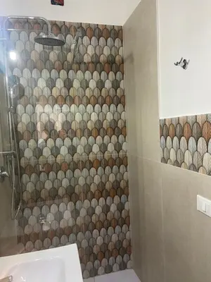 a bathroom with a shower with a tiled wall at La Casa di Peppe in Capaci