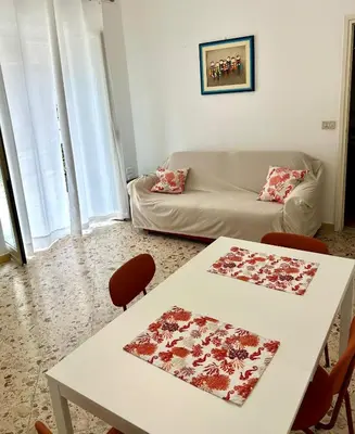 a living room with a white table and a couch at Casa Repasi in Sferracavallo