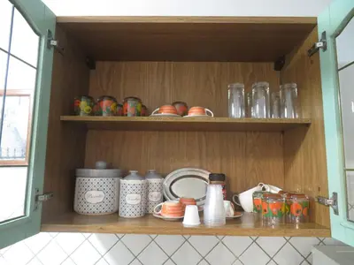 a cupboard with dishes and other items in it at Casa Repasi in Sferracavallo