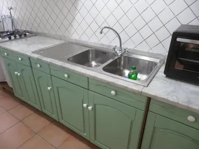 a kitchen sink with a green bottle in it at Casa Repasi in Sferracavallo