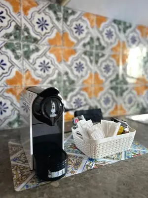 a kitchen with wooden cabinets and a counter top at Sikelia Apartment in Palermo