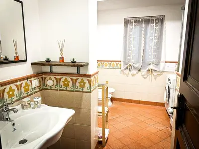 a bathroom with a sink and a toilet at Sikelia Apartment in Palermo