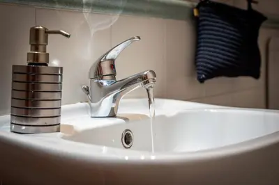 a sink with a faucet on a white sink at Sicilia Bella Maqueda in Palermo