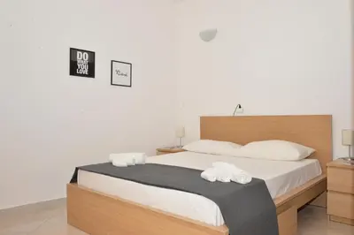 a bedroom with a bed with two towels on it at Sicilia Bella Maqueda in Palermo
