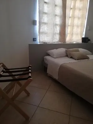 a bed with pillows and towels on top of it at 215 addaura luxury room in Palermo
