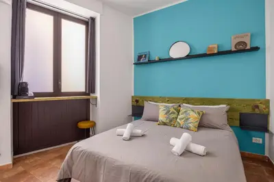 a bedroom with a bed with two white pillows at Suk Ballarò in Palermo