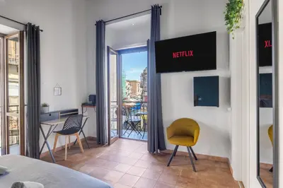 a room with a view of a balcony with chairs at Suk Ballarò in Palermo