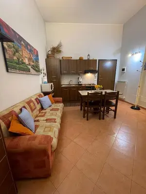 a living room with a couch and a table at Hola Cathedral House Cadorna in Palermo