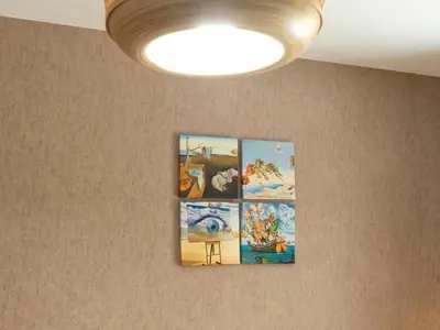 a group of pictures hanging on a wall with a light at Sunset House in Balestrate