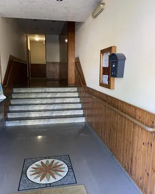a hallway with stairs and a television in a building at Casa Luminaria in Palermo