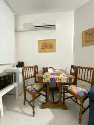 a dining room with a table and two chairs at Casa Luminaria in Palermo