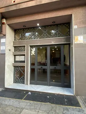 a store front with glass doors on a building at Casa Luminaria in Palermo
