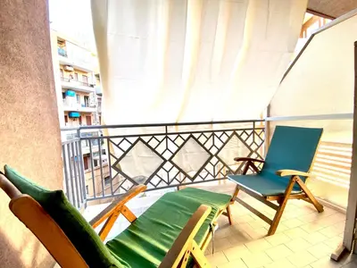 a balcony with two chairs and a blue chair at Casa Luminaria in Palermo