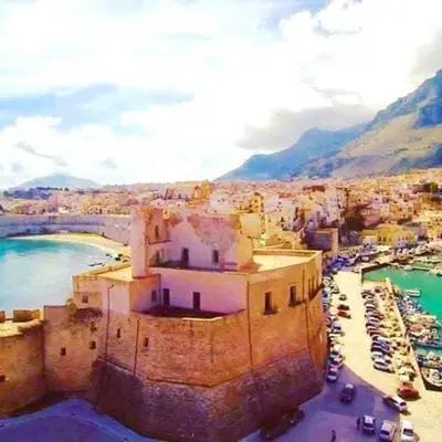 an aerial view of a town with boats in a harbor at La Rosa Dei Venti in Castellammare del Golfo