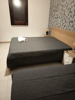 a bedroom with a large bed in a room at La Rosa Dei Venti in Castellammare del Golfo