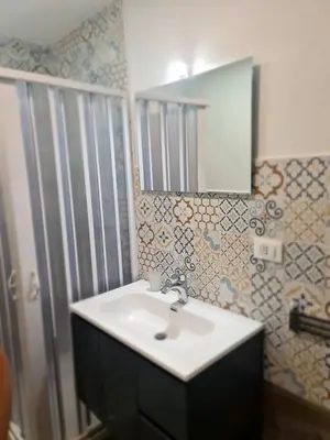 a bathroom with a sink and a mirror at Casa mulini in Palermo