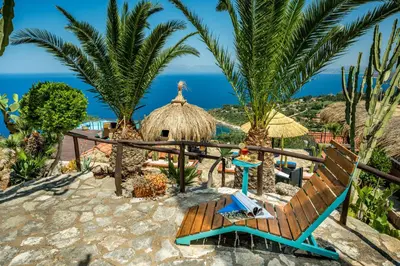 a resort with a view of the ocean at Palma Dello Zingaro in Scopello